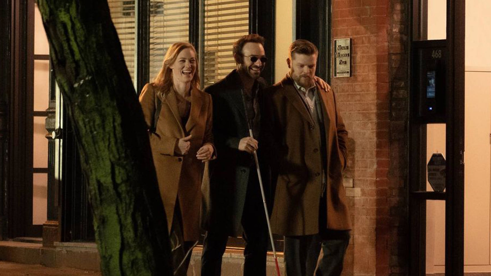 Karen Page, Matt Murdock, and Foggy Nelson walking along laughing together on a New York street in Daredevil: Born Again. - 1