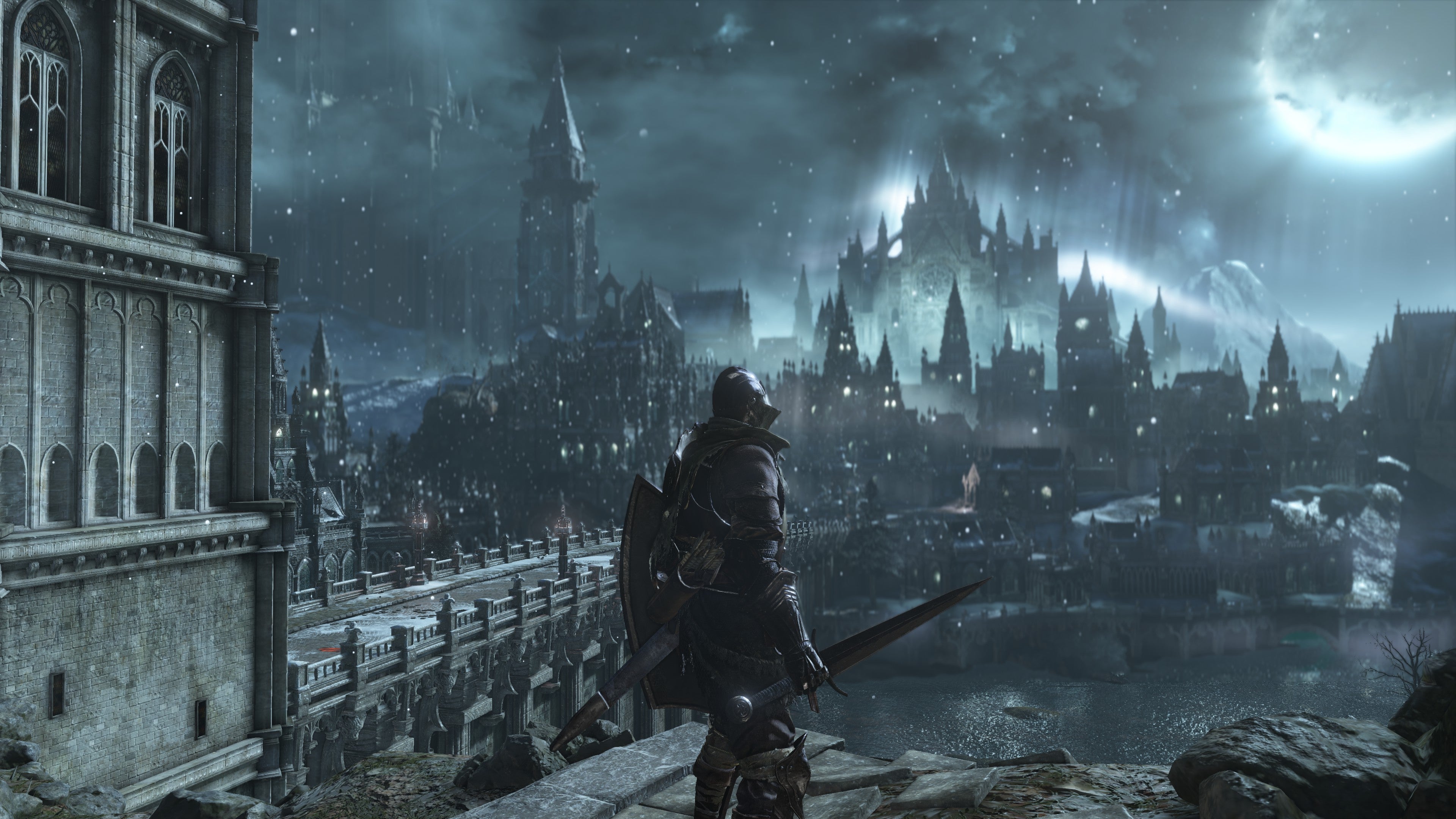 Gameplay screenshot from Dark Souls 3, showing a boss arena with a large, imposing structure.