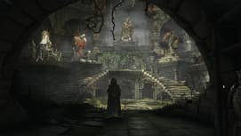 A person wearing a hood is stood in a sanctuary with stone statues of various figures on pedestals displayed around it in Dark Souls Archthrones.
