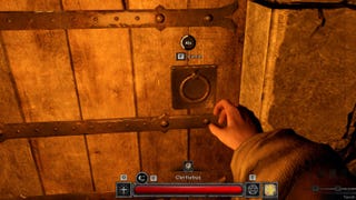 A screenshot of a hand reaching out to open a locked wooden door in a dungeon. What's on the other side?