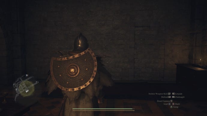 The player in Dragon's Dogma 2 spies a secret passage in a stone brick wall.