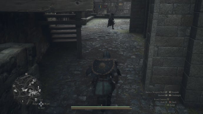 The player in Dragon's Dogma 2 chases after a brown-cloaked figure in Vernworth.