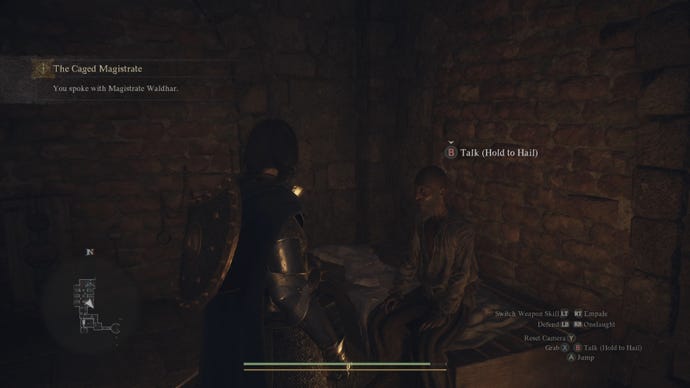 The player speaks to Magistrate Waldhar in his gaol cell in Dragon's Dogma 2.