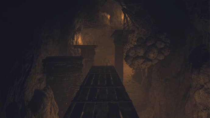 An establishing shot of the obstacle course of seesaws and boulders in the Nameless Village Depths in Dragon’s Dogma 2.
