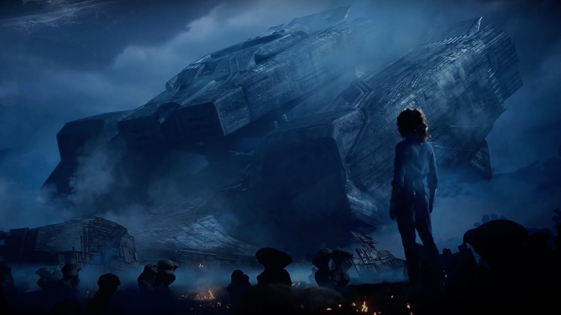 Ellen Ripley, viewed from behind, surveys the wreckage of the downed ship Nostromo, moodily rendered against a dark sky.