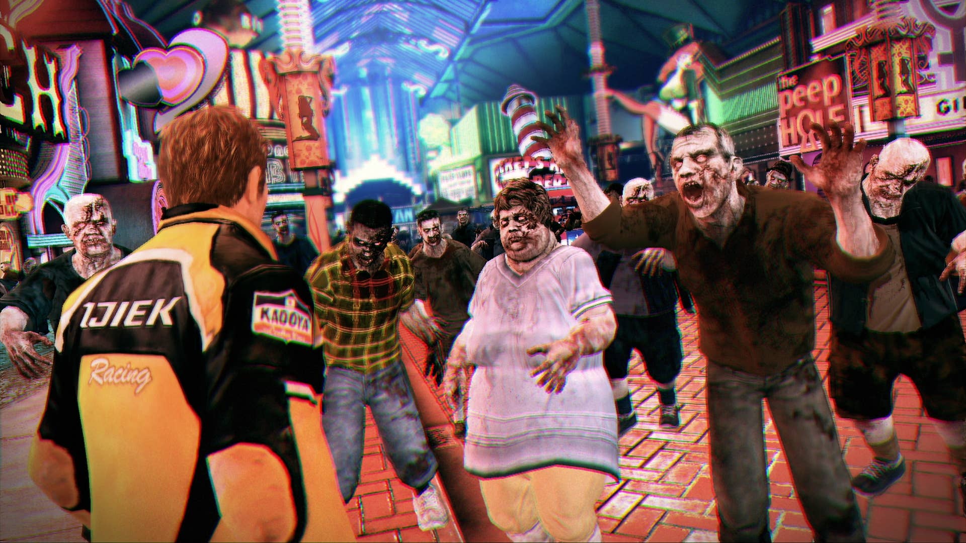 Chuck Greene, in a yellow motorbike jacket, faces a crowd of the undead.