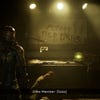 Isaac look at some graffiti in Dead Space