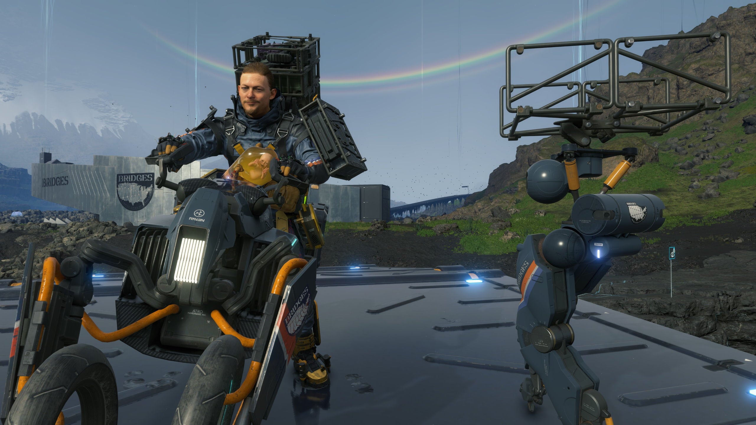 Sam rides a bike with a buddy bot in tow in Death Stranding Director&rsquo;s Cut