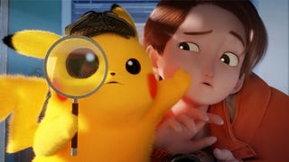 Detective Pikachu holds a magnifying glass and looks at the camera. He has one paw on Tim's face, pushing him out of the way