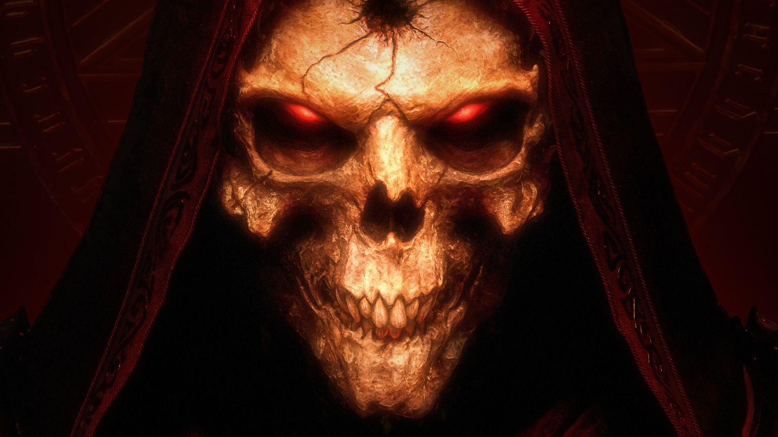 A close-up image of a scary skulled face with glowing red lights in the eye sockets and a fractured bullet-hole like crack in the forehead. A hood is pulled up over the skull. It's Diablo from Diablo 2.