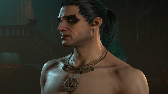 Diablo 4 Ice Shard Mage Build: A man with green hair, a ponytail, and heavy eyeshadow stands in a dark room. He was shirtless and wore a heavy gold pendant around his neck.