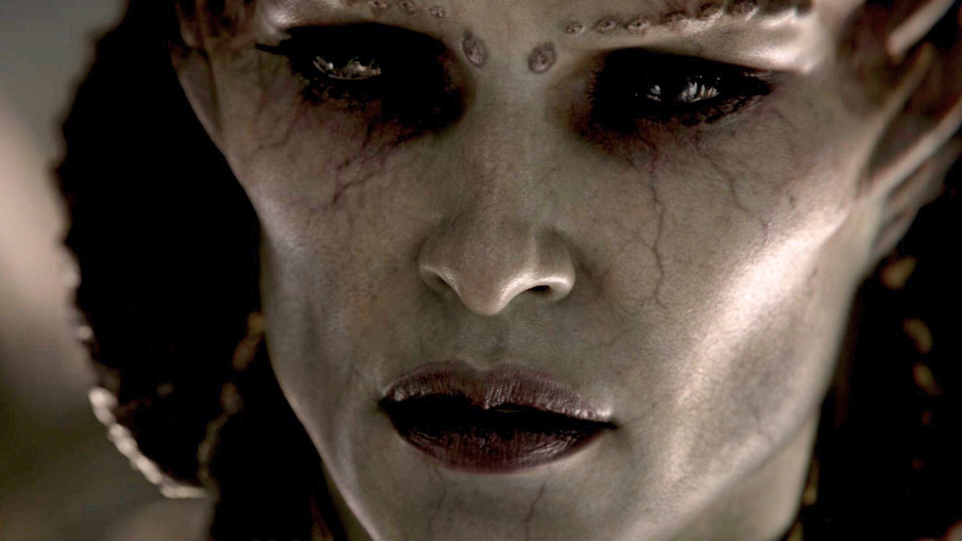 A close-up on Diablo 4&rsquo;s Lilith as she sneers.