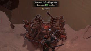 A player in Diablo 4 stands next to a Tortured Gift Of Mysteries in a Helltide region.