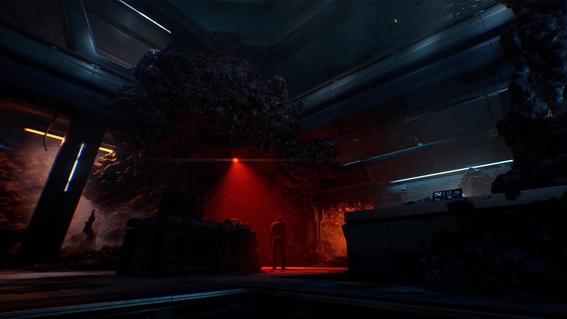 A dark interior of a kind of underground laboratory of some kind. Red light barely pierces the dark.