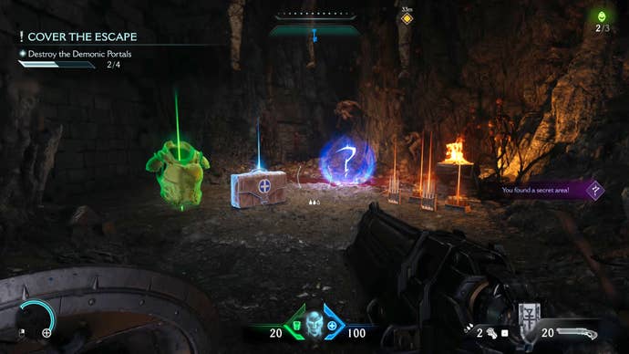 The player in Doom: The Dark Ages walks towards a secret cave area with a number of pickups on the floor in Chapter 1.