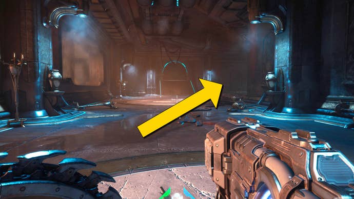 The player in Doom: The Dark Ages heads down a hallway towards a large barred door. A yellow arrow signals for the player to turn right before they reach the door.