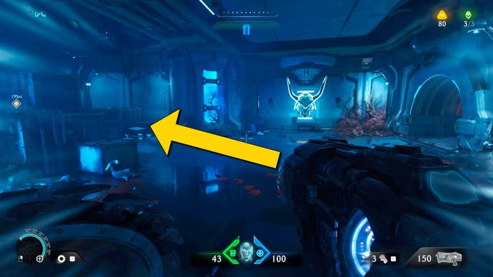 The player in Doom: The Dark Ages stands in a blue-lit room with a large helmet hologram at the end. A yellow arrow points to the left.