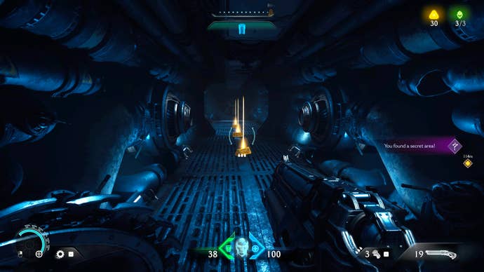 The player in Chapter 2 of Doom: The Dark Ages walks down a dimly lit ventilation shaft secret area and towards some Gold on the floor.