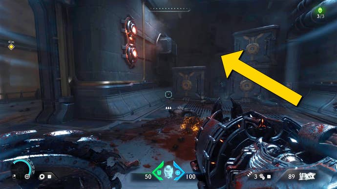 The player in Doom: The Dark Ages looks at a stack of crates in a corridor in Chapter 2. A yellow arrow signals for the player to jump over the crates.