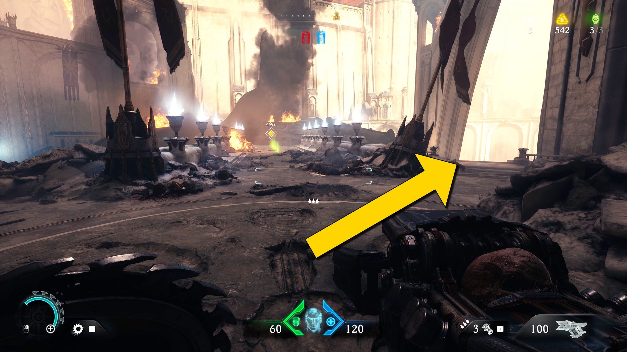 The player in Doom: The Dark Ages stands outside a building in Chapter 5 and looks towards a bridge lined by sconces and armour floor pickups. A yellow arrow points towards a gap in the fence on the right-hand side. - 37