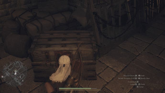 dragons dogma 2 a white haired arisen player is opening a chest in the guardhouse