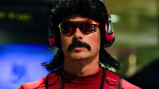 An image showing Dr Disrespect onstage, wearing headphone and sunglasses.