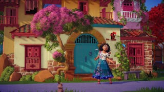 Dreamlight Valley bunuelos recipe: An animated girl with curly black hair, wearing a white shirt and floral skirt, is standing in front of a large, multicolored house with red window shutters and bright pink flowering trees in front