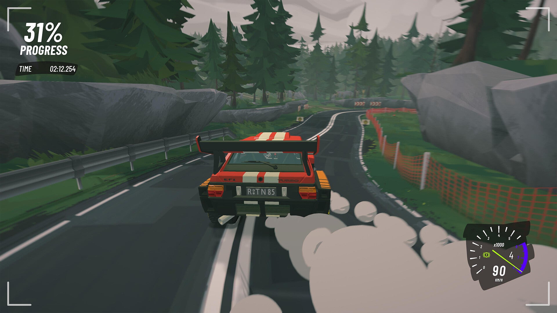 A red rally car blazes around a woodland rally course in #Drive Rally. - 1