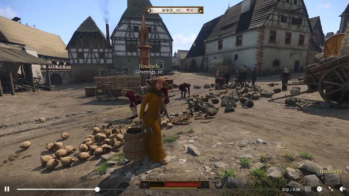 A still from a video of NPCs gathering dropped objects in Kuttenberg in Kingdom Come: Deliverance 2
