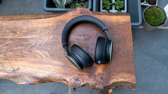 Microsoft's Xbox Wireless Headset sitting on a wooden bench outside with plants visible in the background