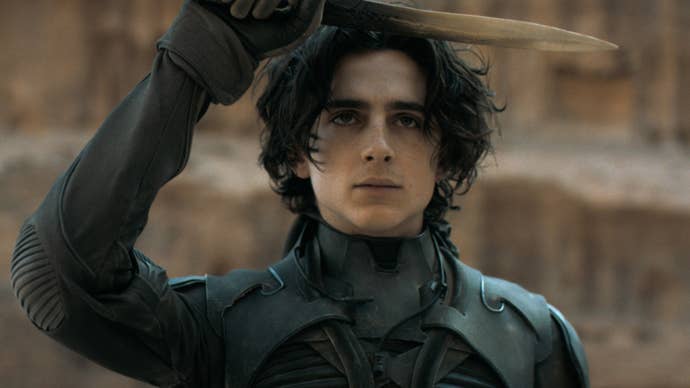 Timothee Chalamet in Dune: Part Two, he’s holding up a dagger above his head, looking forwards.