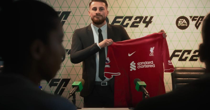 A footballsman holds his new shirt aloft at a press conference in EA Sports FC 24.