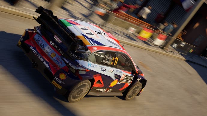 A screenshot of EA Sports WRC showing a rally car on the road.