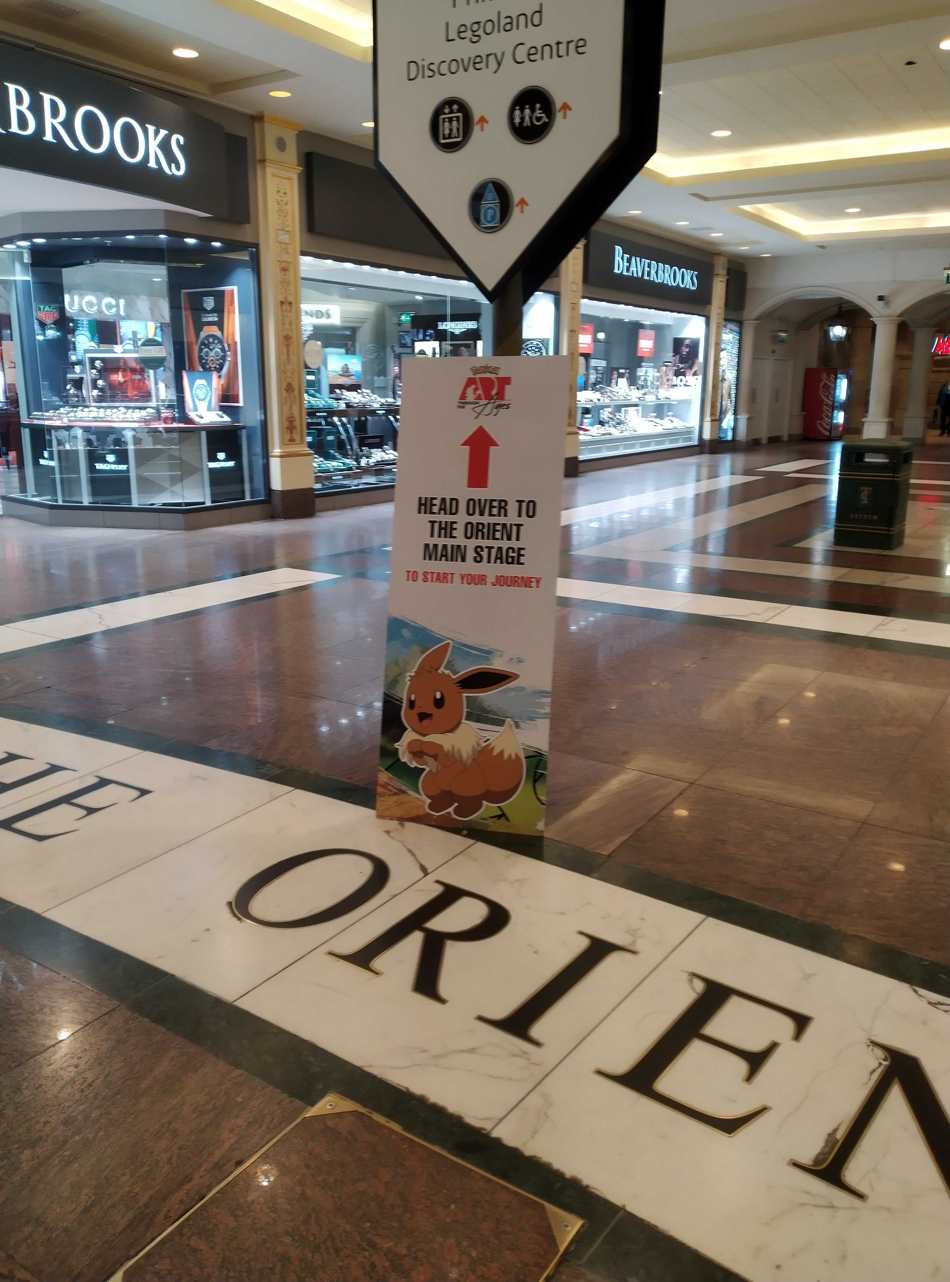 Pokémon: Art Through the Ages sign with Eevee showing directions to The Orient