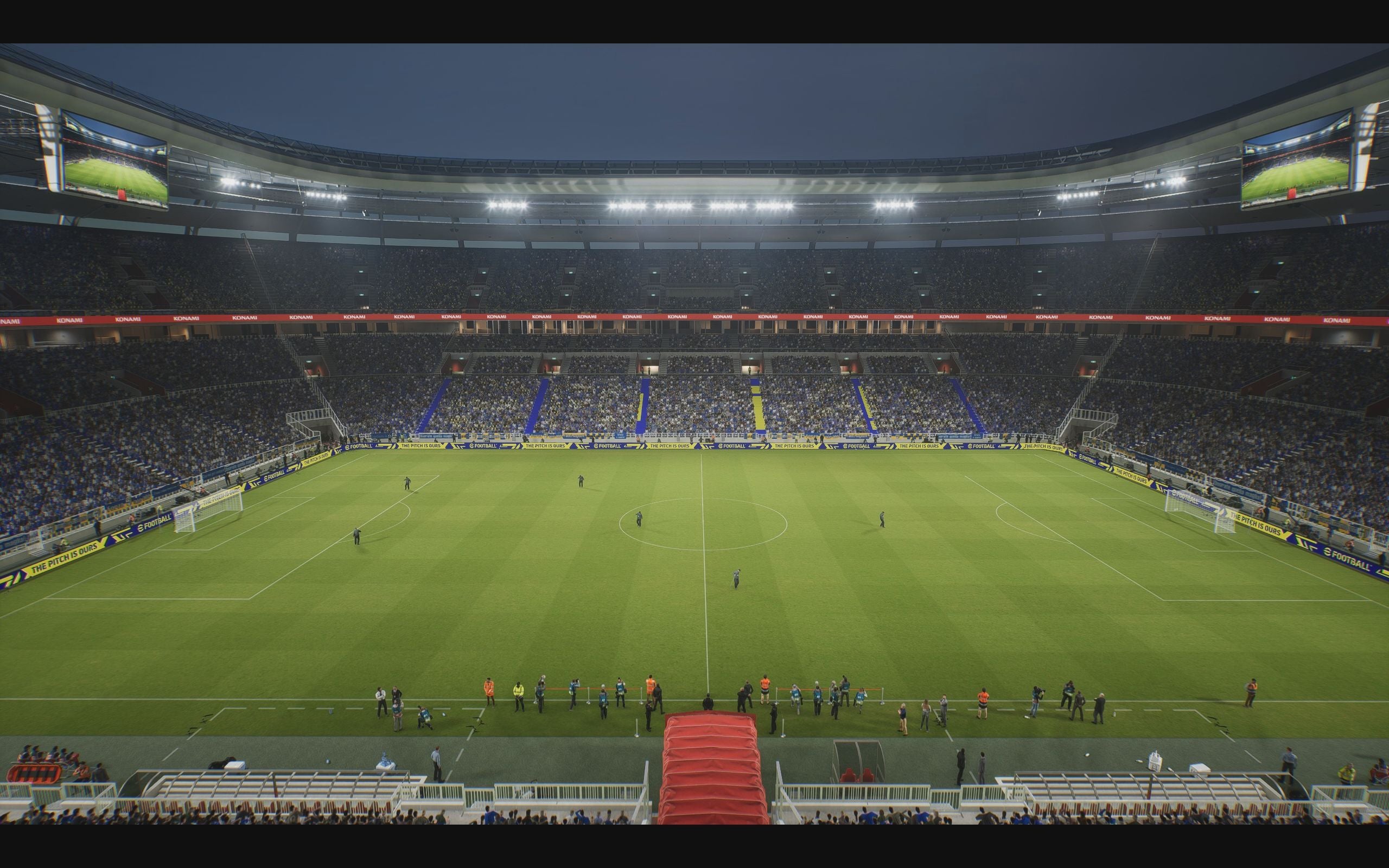 eFootball review: A TV-style wide-shot of the pitch and stadium before a match, viewed side-on from in-line with the halfway-line.