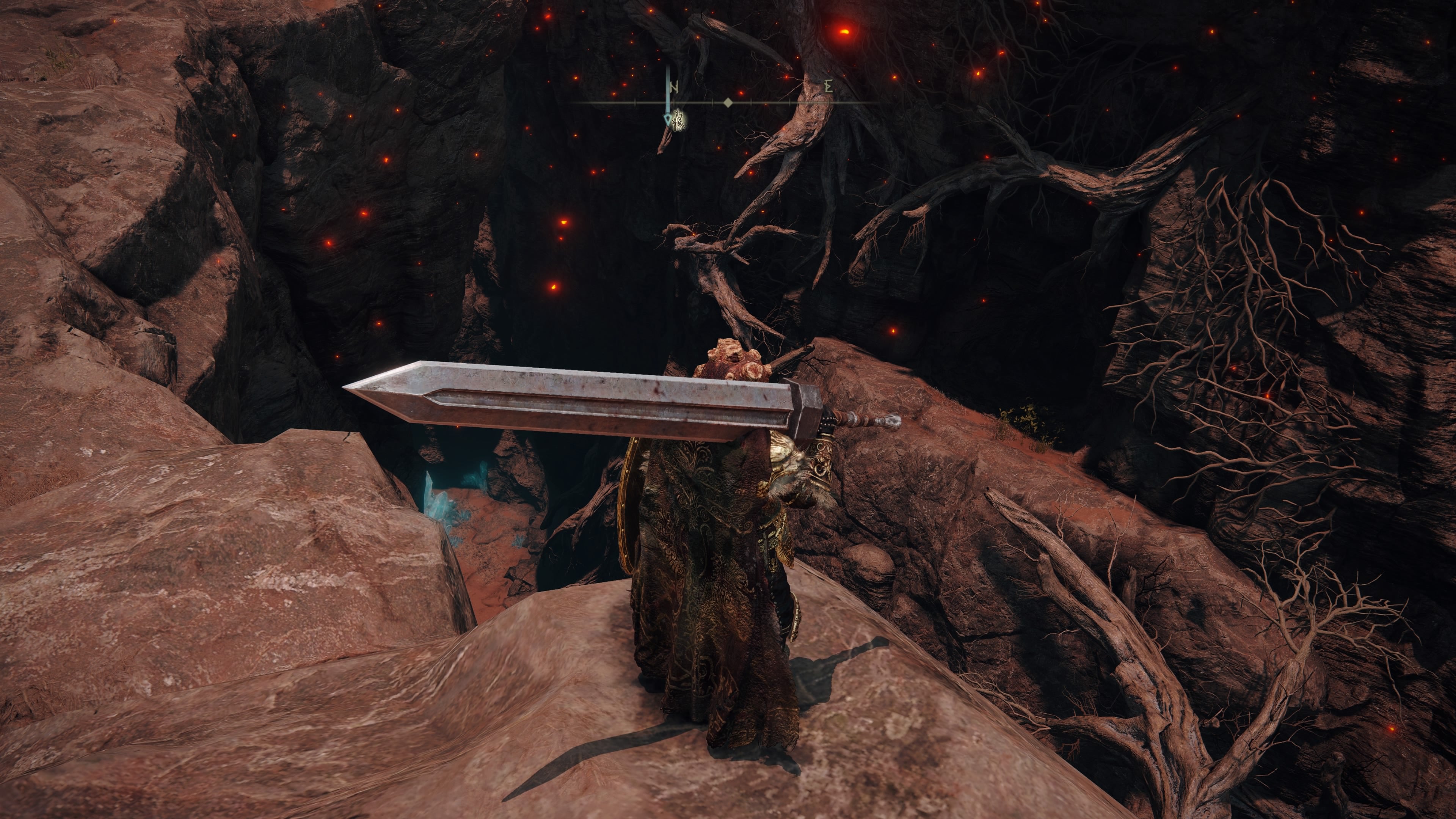 A warrior stands at the entrance to the Abandoned Cave in Elden Ring