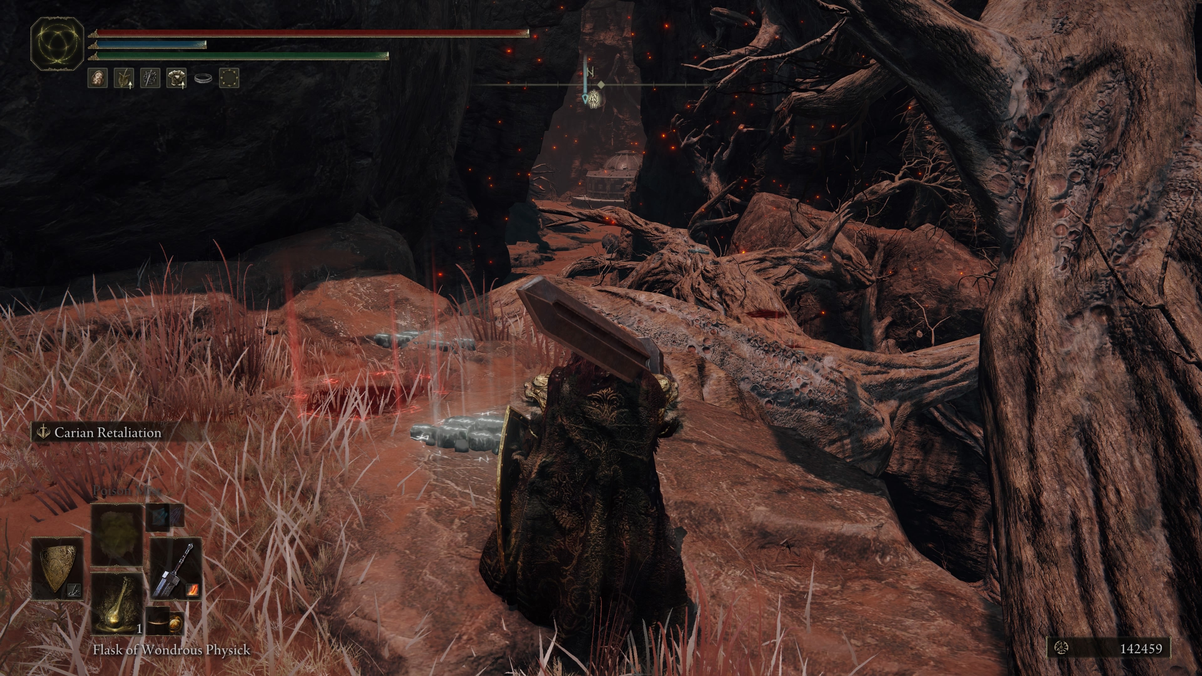 A warrior walks over large branches in the Abandoned Cave in Elden Ring.