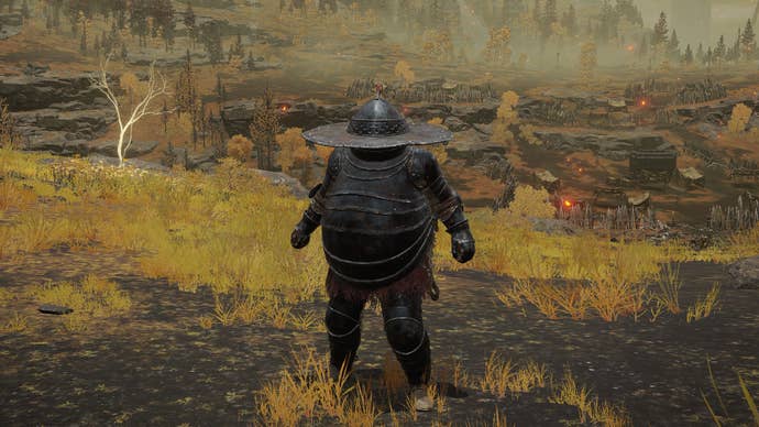 The player in Elden Ring stands in front of the camera wearing Lionel’s armour set. Behind them is a view of the Altus Plateau.