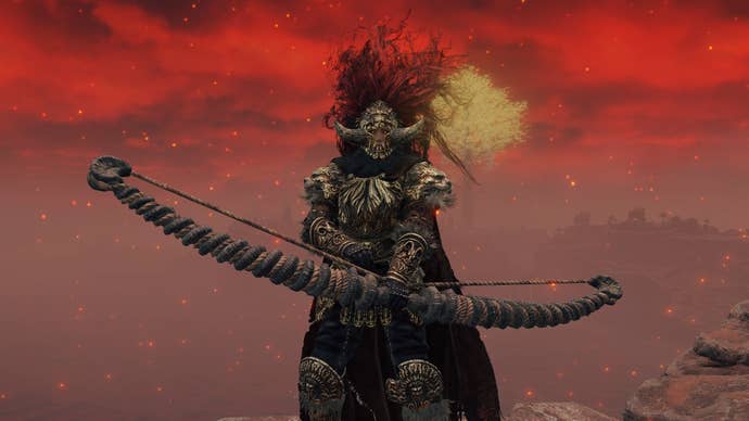 A warrior holds the Golem Greatbow against a red sky in Elden Ring.