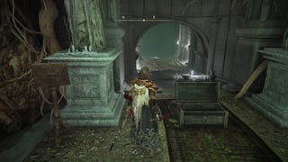 A warrior stands in an underground tunnel in the Cathedral of the Forsaken in Elden Ring.