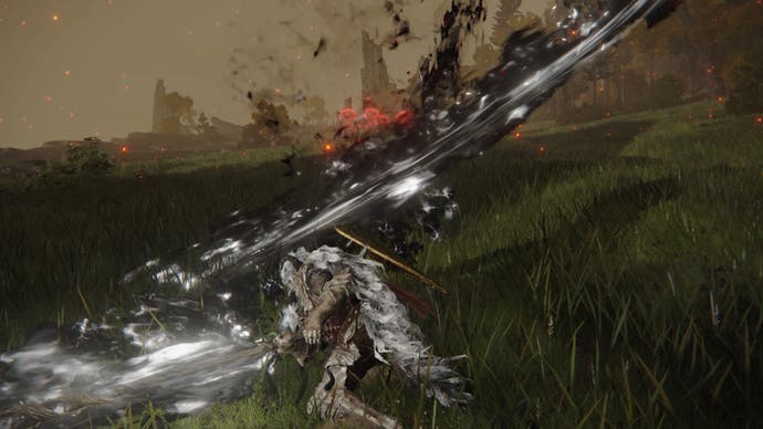 The player slashes with the Godslayer's Greatsword colossal weapon, creating an arc of black flame, in Elden Ring