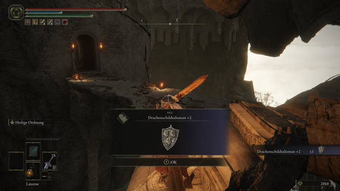 A warrior obtains the Dragoncrest Shield Talisman +2 in Crumbling Farum Azula in Elden Ring.