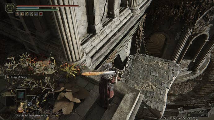 A warrior prepares to drop down to a lower platform in Crumbling Farum Azula in Elden Ring.