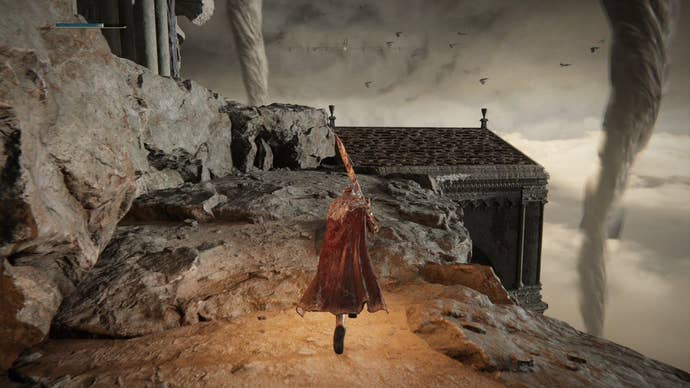 A warrior ascends up a rocky clifftop to a building rooftop in Crumbling Farum Azula in Elden Ring.