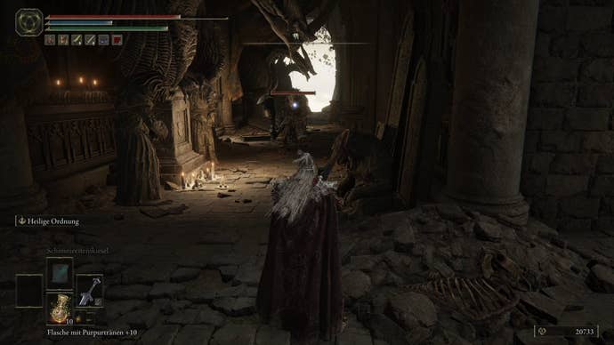 A warrior approaches a monster din a hallway of dragon statues in Crumbling Farum Azula in Elden Ring.