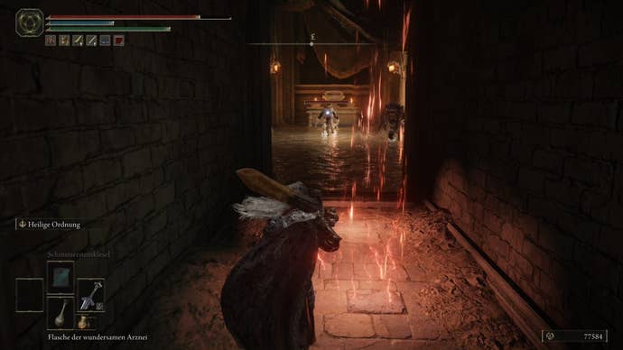 A warrior prepares to dodge some red lightning on the floor in Crumbling Farum Azula in Elden Ring.