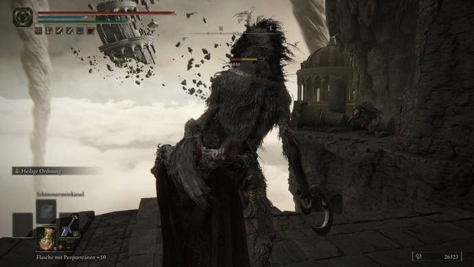 A warrior attacks a monster in Crumbling Farum Azula in Elden Ring.