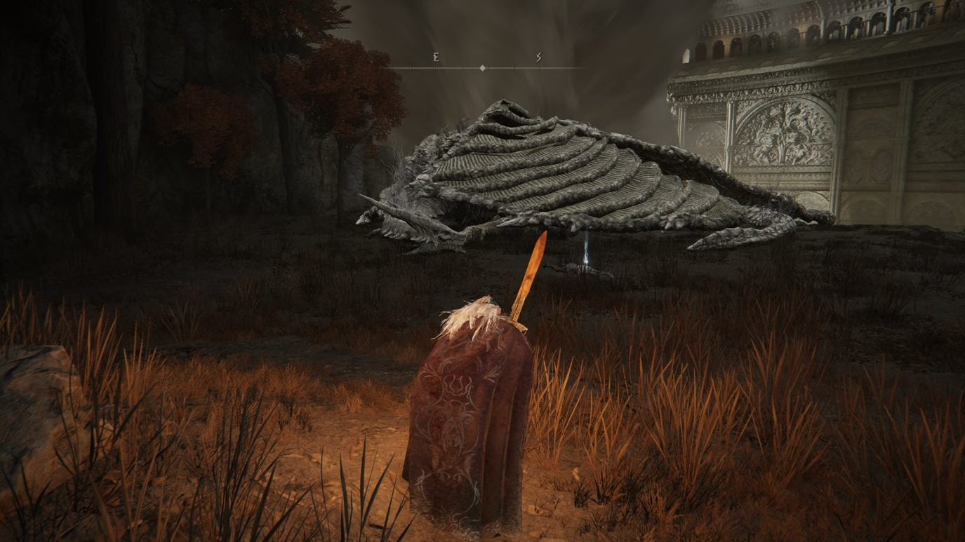 A warrior approaches a sleeping dragon in Crumbling Farum Azula in Elden Ring.