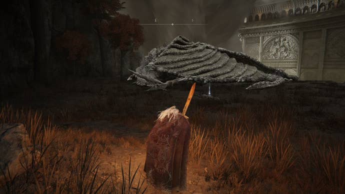 A warrior approaches a sleeping dragon in Crumbling Farum Azula in Elden Ring.