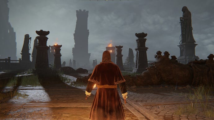 Elden Ring player stands holding a torch before some statues on Limgrave Tower Bridge, staring up at the Divine Tower of Limgrave